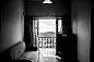 Black and white shot of worn down sofa and balcony window with view from flat, Kodaikanal