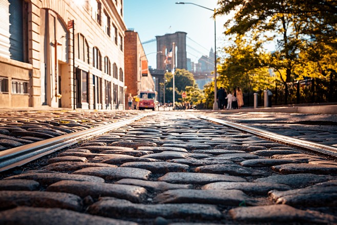 worms eye view street road brooklyn bridge sunlight new york