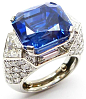 Single stone sapphire and diamond cluster ring by Cartier, Paris, the cut-corner rectangular Ceylon sapphire, 17.55ct,  claw set in landscape and flanked by collet set kite shaped diamonds, raised in high pavй diamond set mount of faceted design, serial n