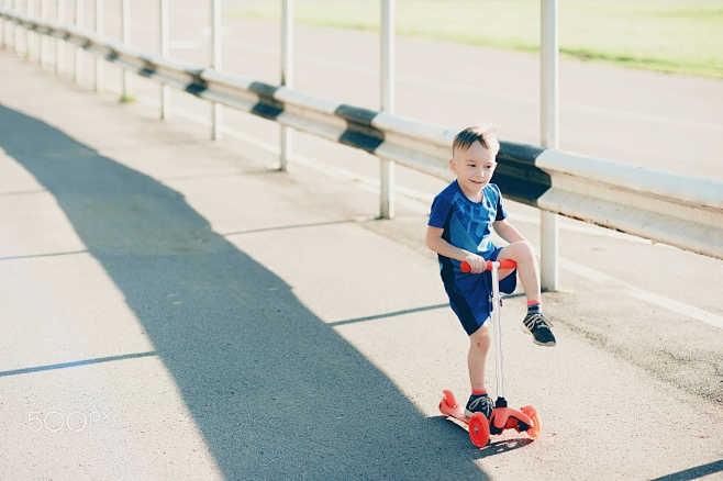 littleboyonascooterinacityparkoutdoors
